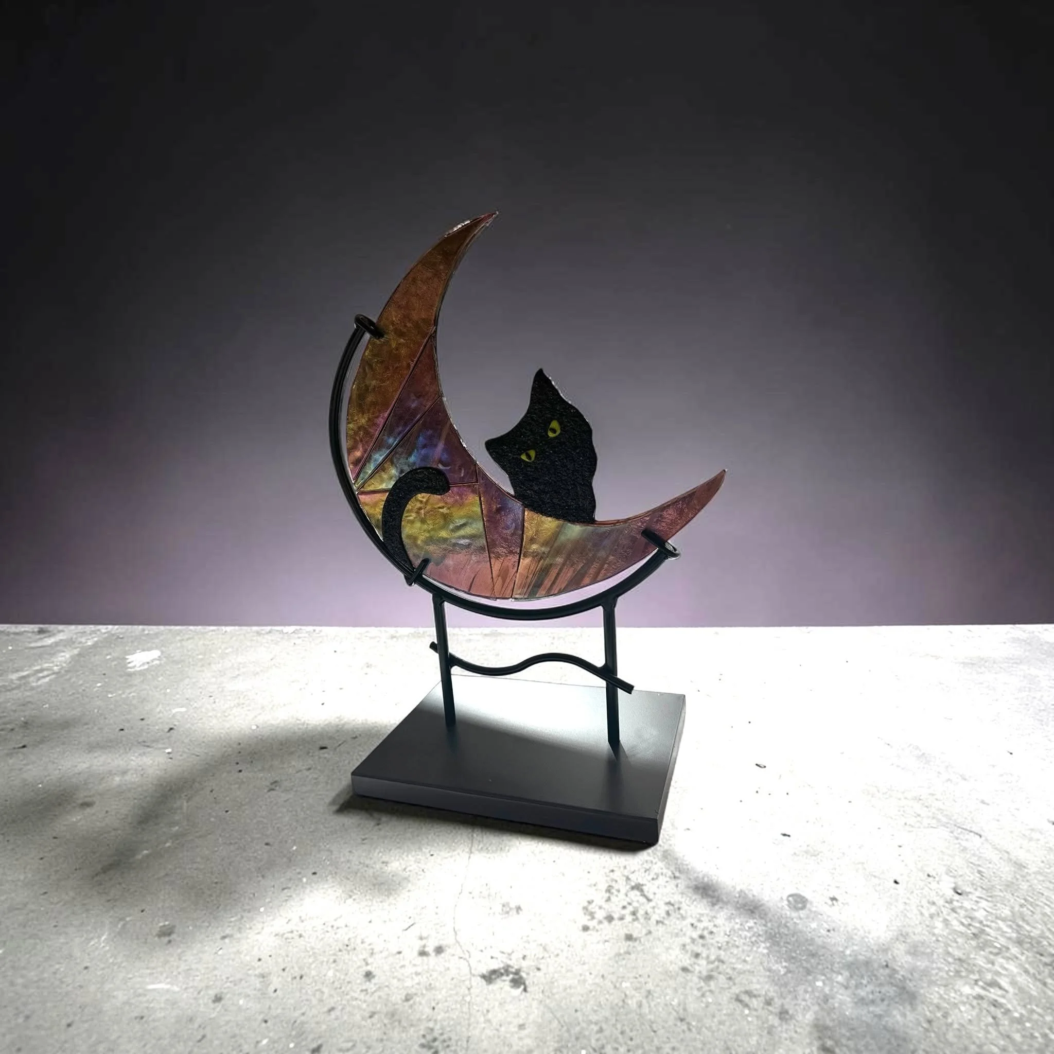 Fusion artist Karen Letkowski has created the ideal holiday decoration: &ldquo;The Cat in the Moon.&rdquo; You'll notice that the color reflection changes as the angle shifts. Iridescent glass, a special type of glass, exhibits a stunning, rainbow-li