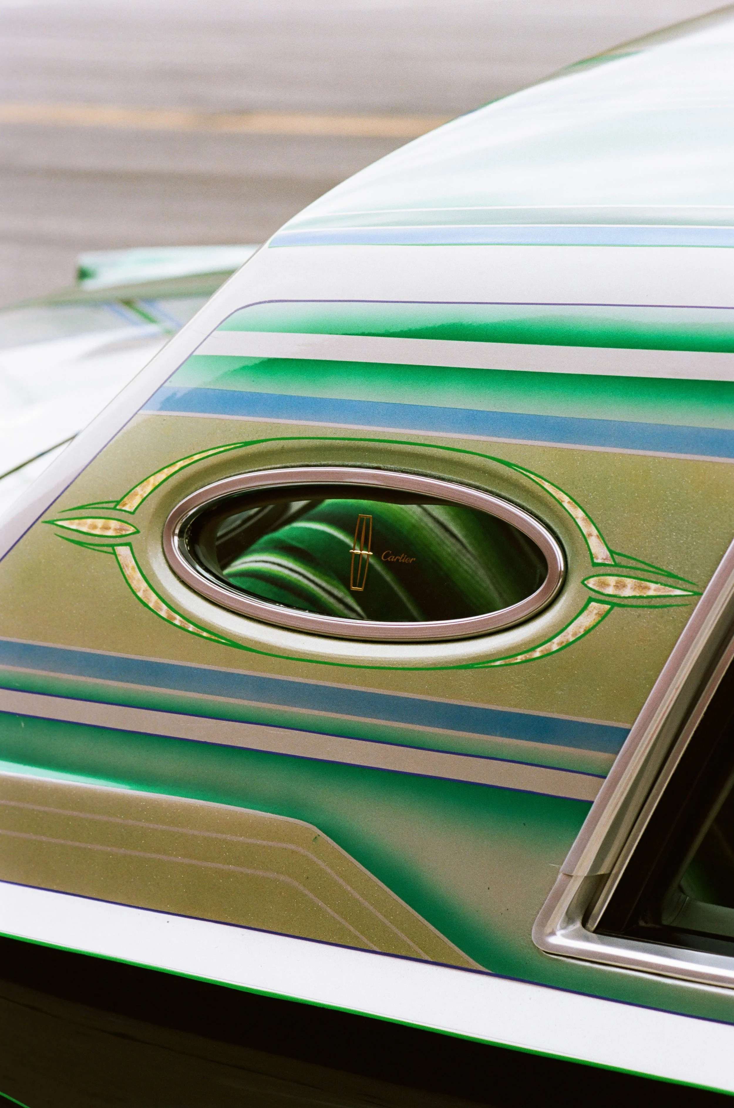 Close-up photo of a vintage or retro-styled jukebox with colorful horizontal stripes and a circular speaker or display area.