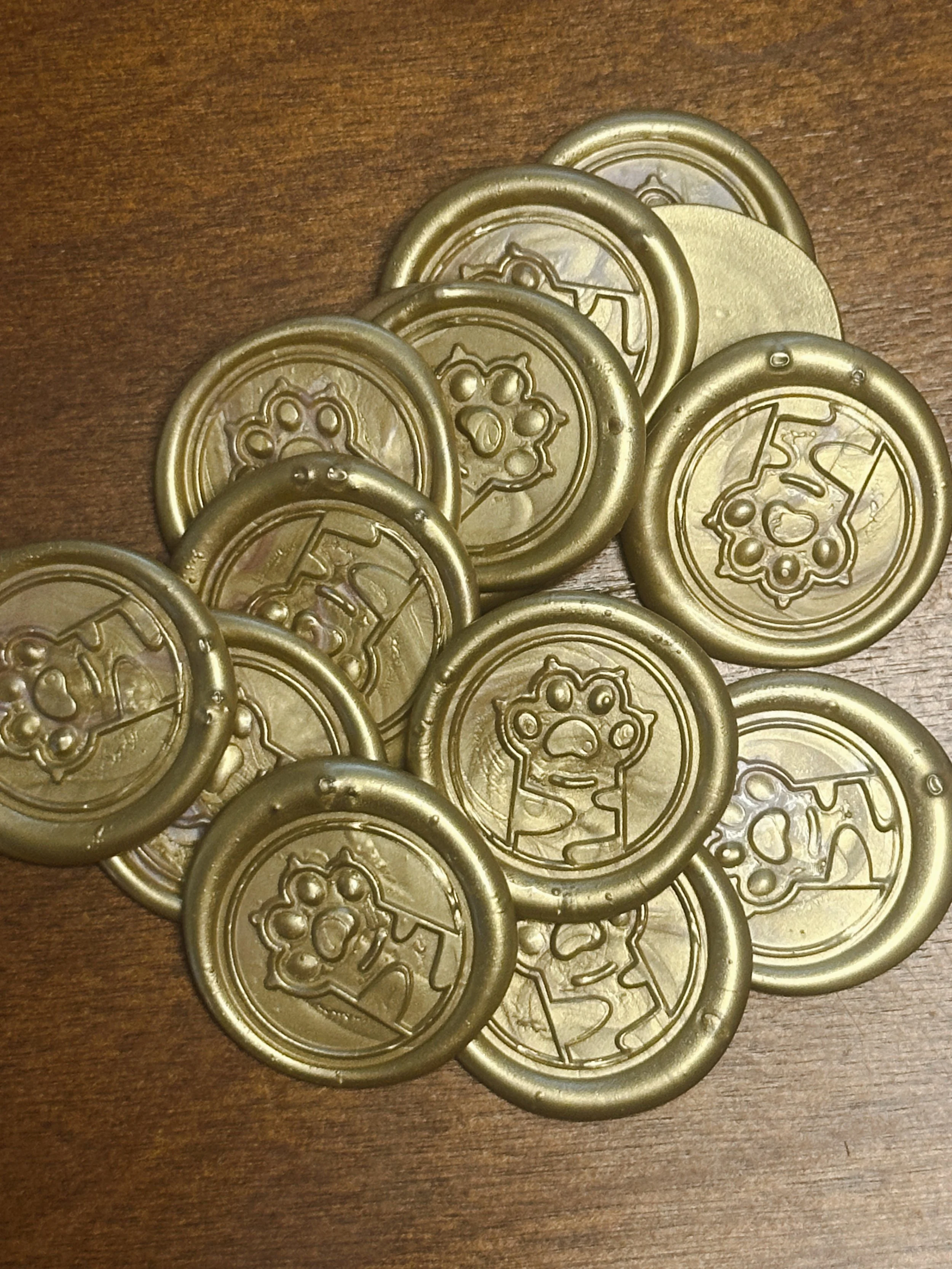 A group of gold-colored game tokens with a cartoon dog face design on each, placed on a wooden surface.