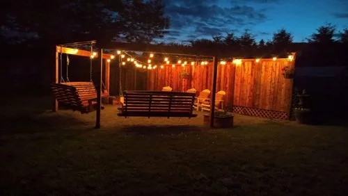 Outdoor 3 porch swings with fire pit and outdoor lights