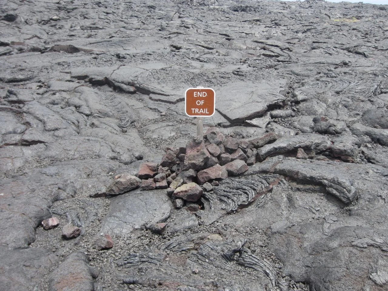 Lava terrain with a small sign reading 'End of Trail' in the middle.
