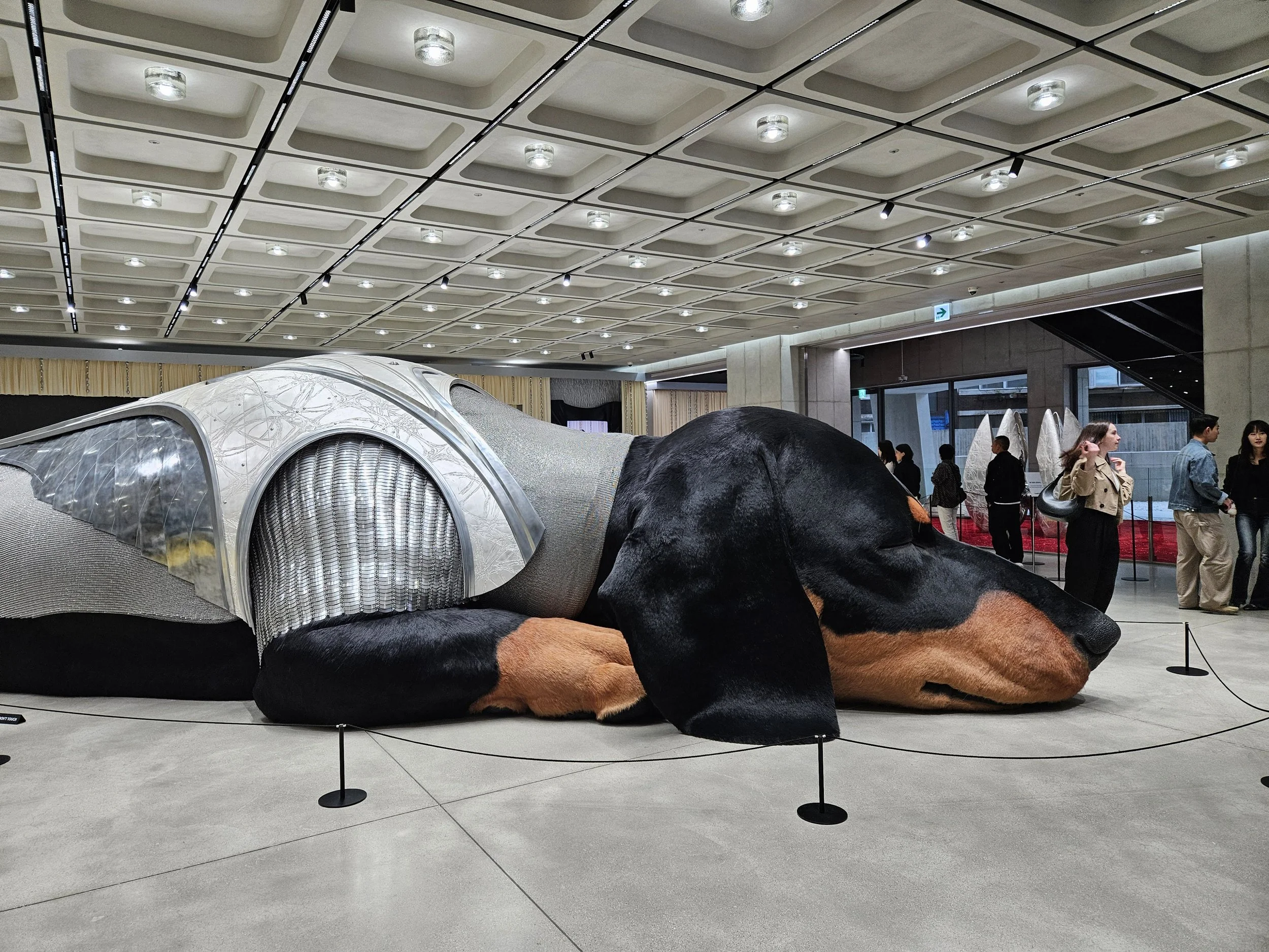 famous wiener dog sculpture in korea with people around the art