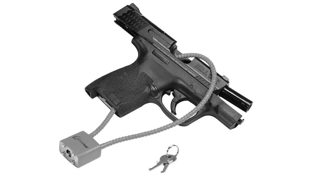 A handgun secured with a cable lock, connected to a trigger lock device and a key is nearby.