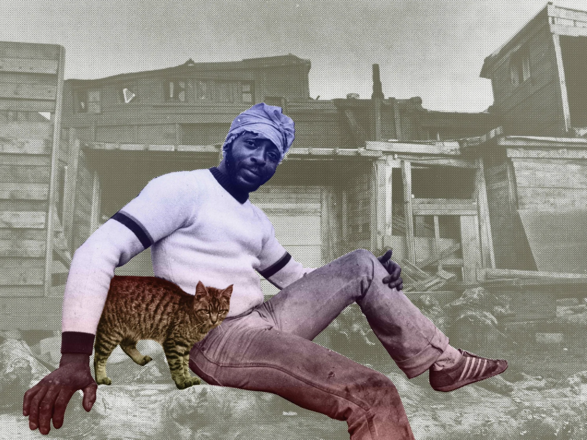 A ashy photo of a man with a purple headwrap, white sweater with black stripes, and old pants, sitting outdoors in front of damaged buildings, with a cat on his lap.