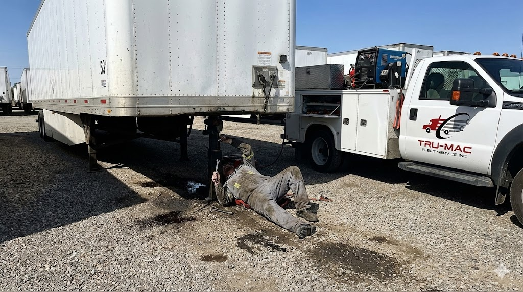 Mobile service truck performing kingpin trailer repair and upper coupler inspection at a fleet yard in Stockton CA