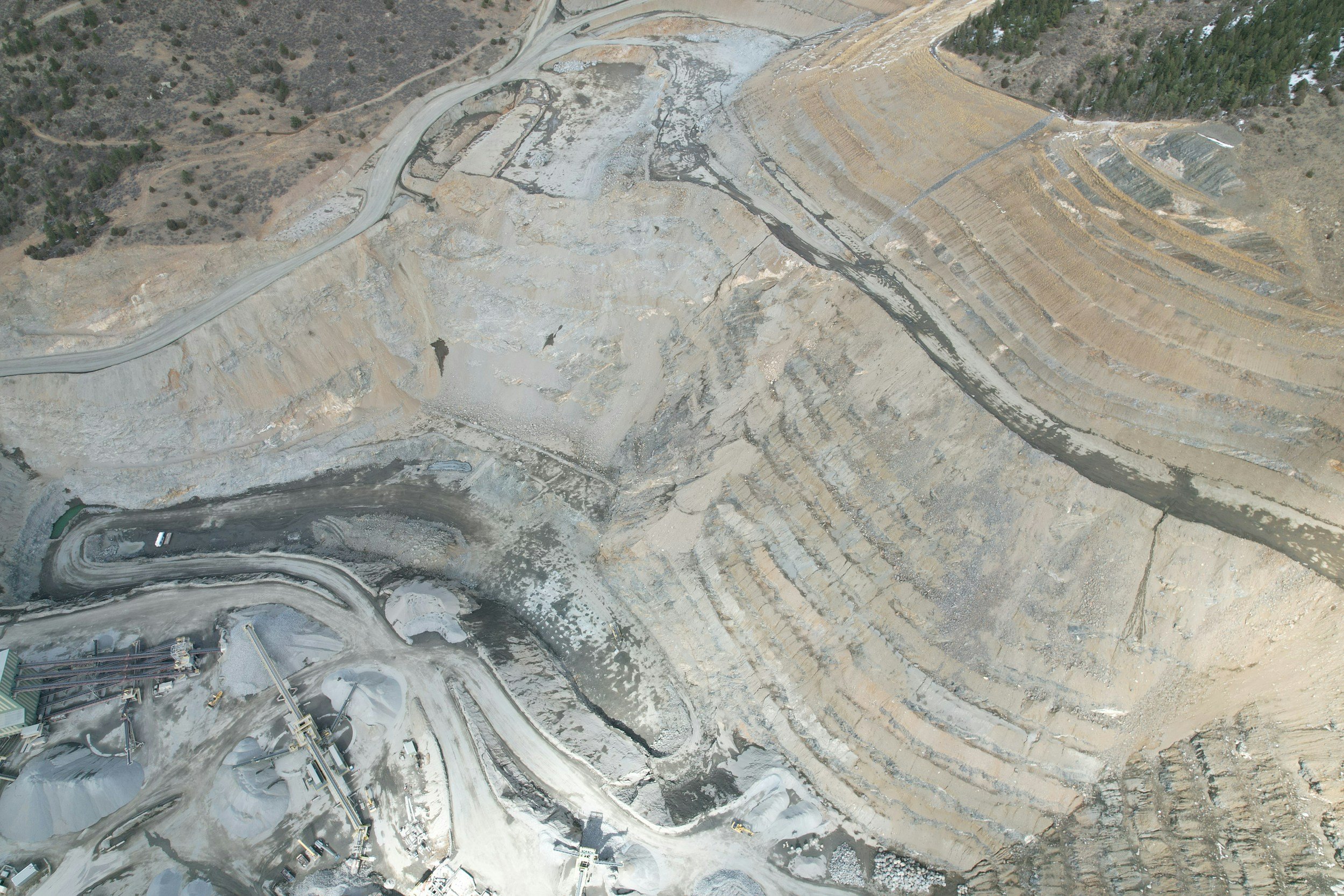 Aerial view of a former industrial quarry site undergoing environmental assessment and brownfield redevelopment planning