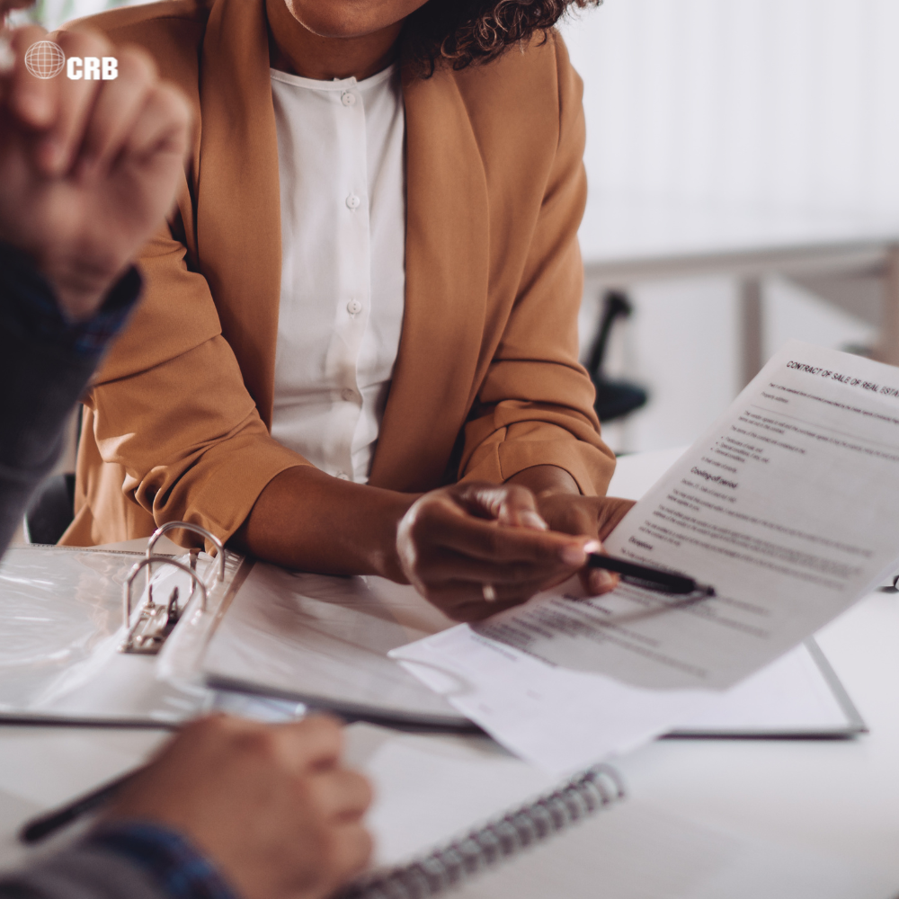 Environmental consultant reviewing regulatory compliance documents and permitting requirements for environmental project