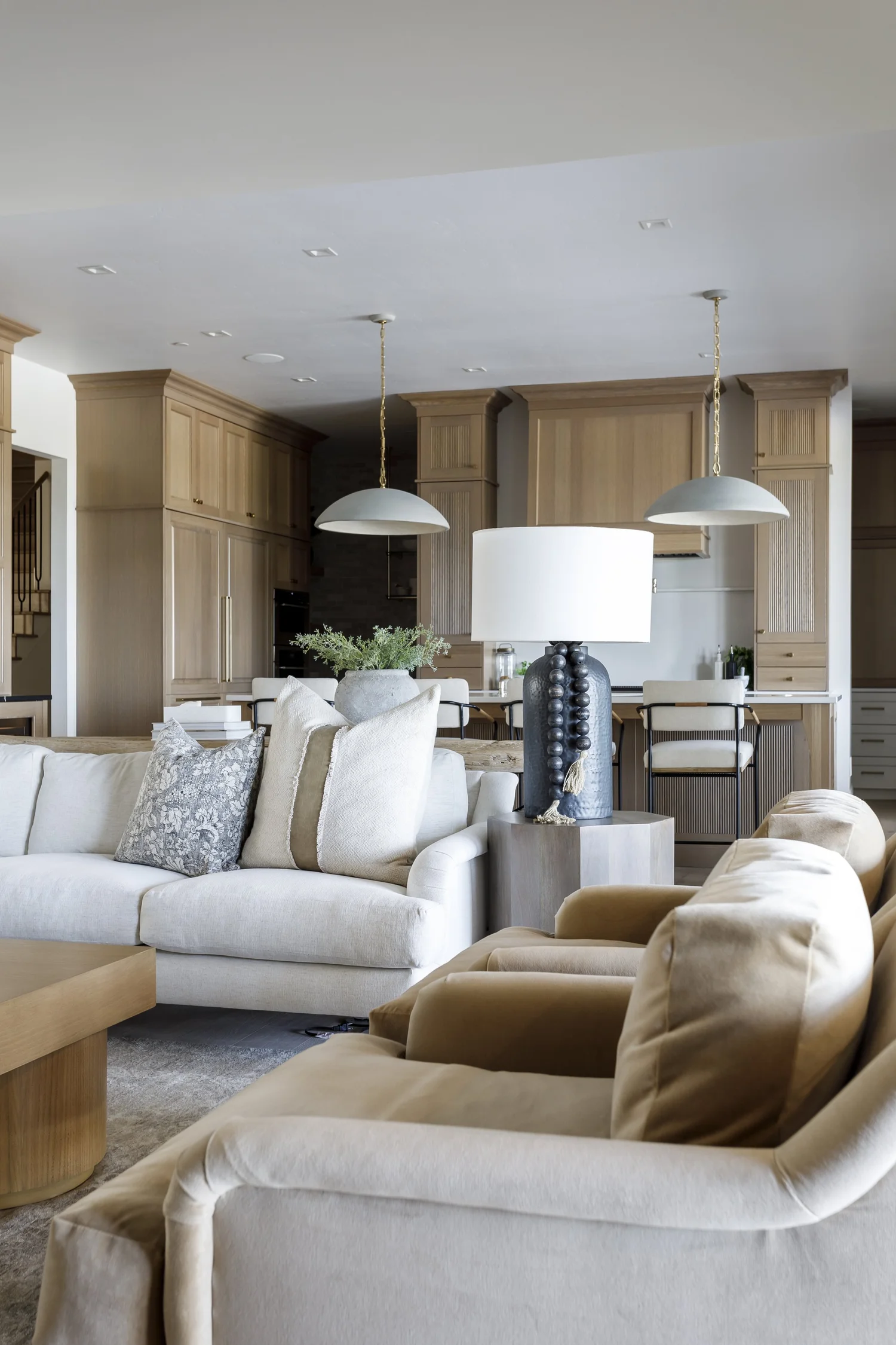sectional sofas, pendants, kitchen beyond