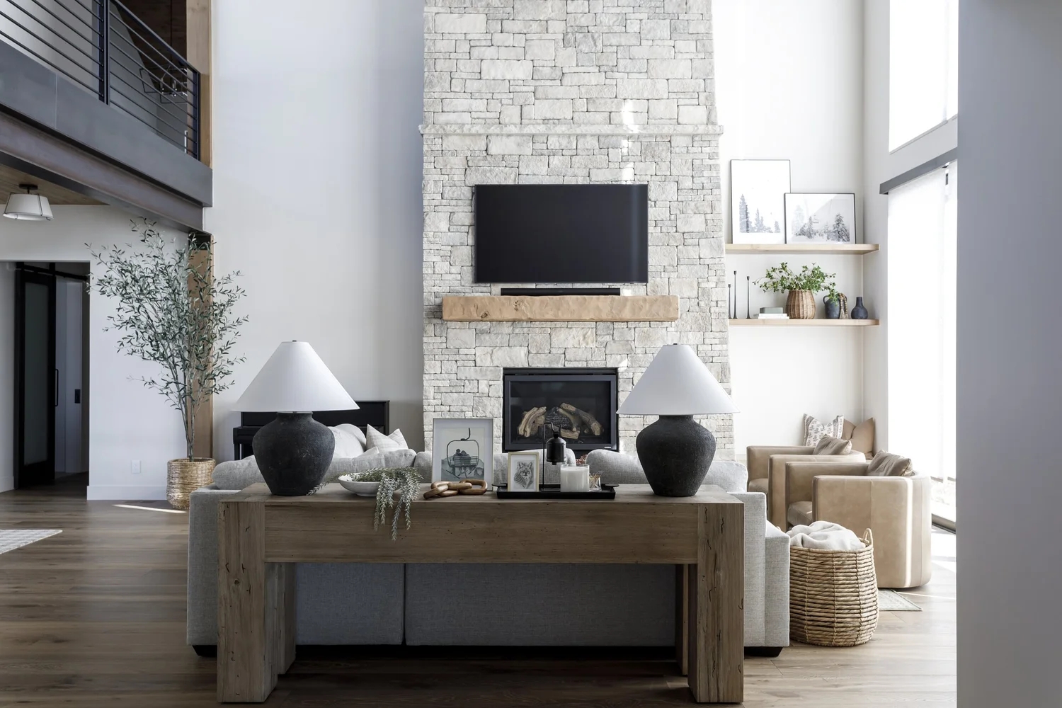 Living room with white brick fireplace and wood console