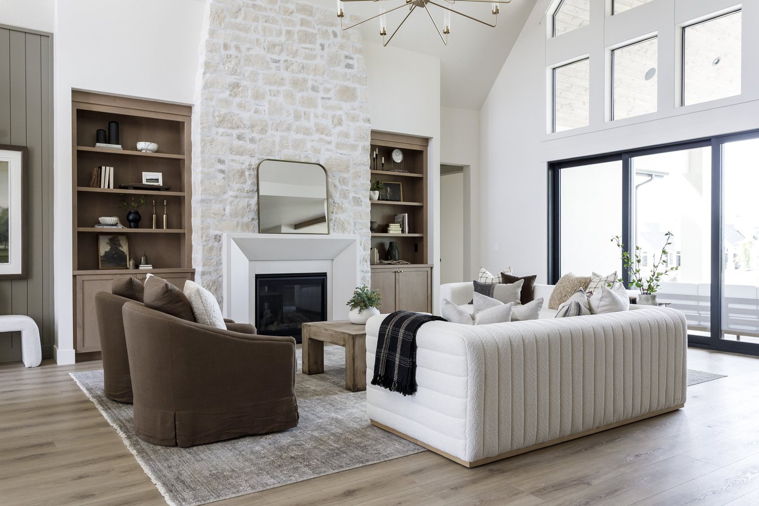 Brown swivel chairs, stone fireplace, sliding doors