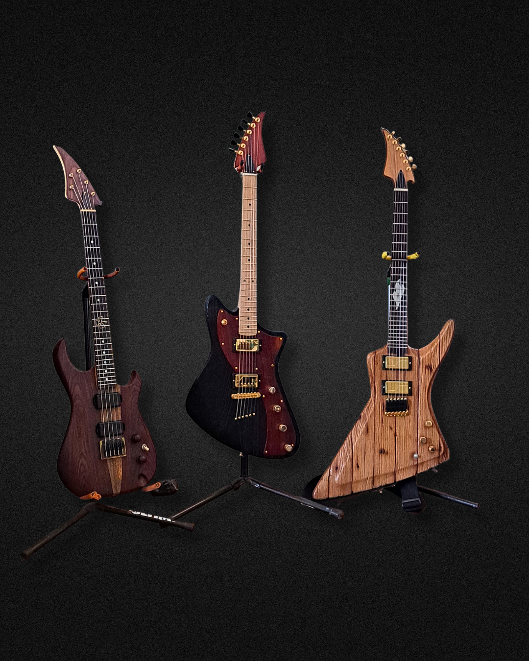 Three electric guitars with unique, artistic designs on black background.