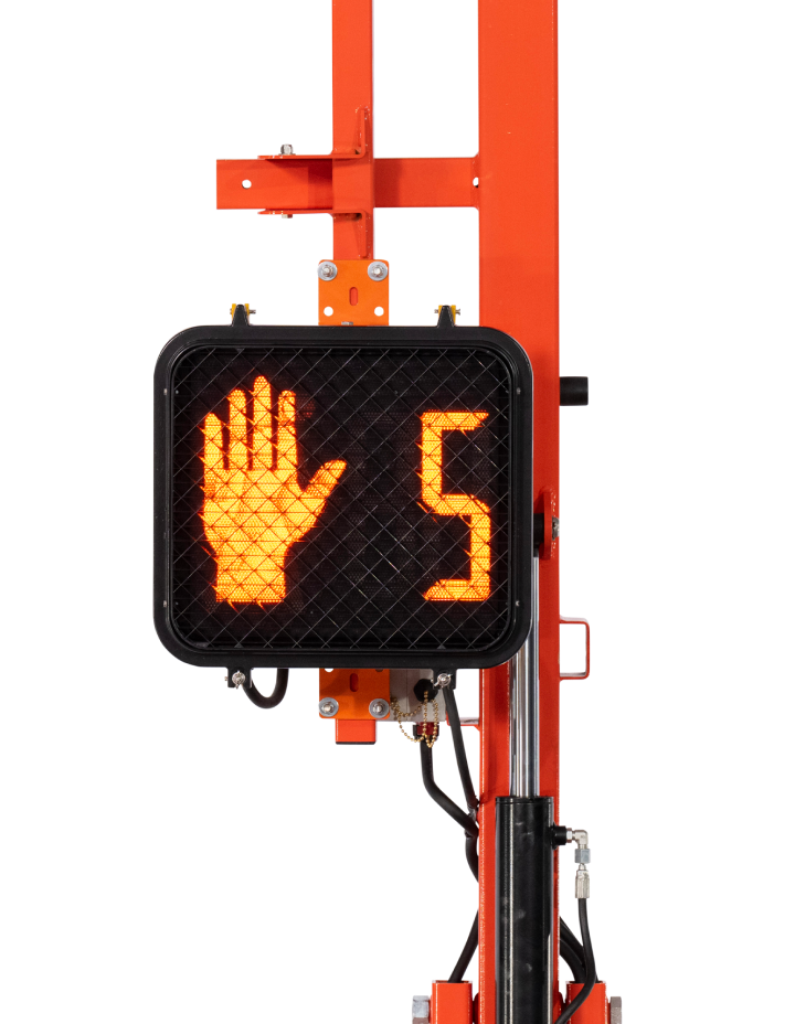 A traffic signal showing a red hand for 'stop' and the number 5 from the HAWK portable traffic light.