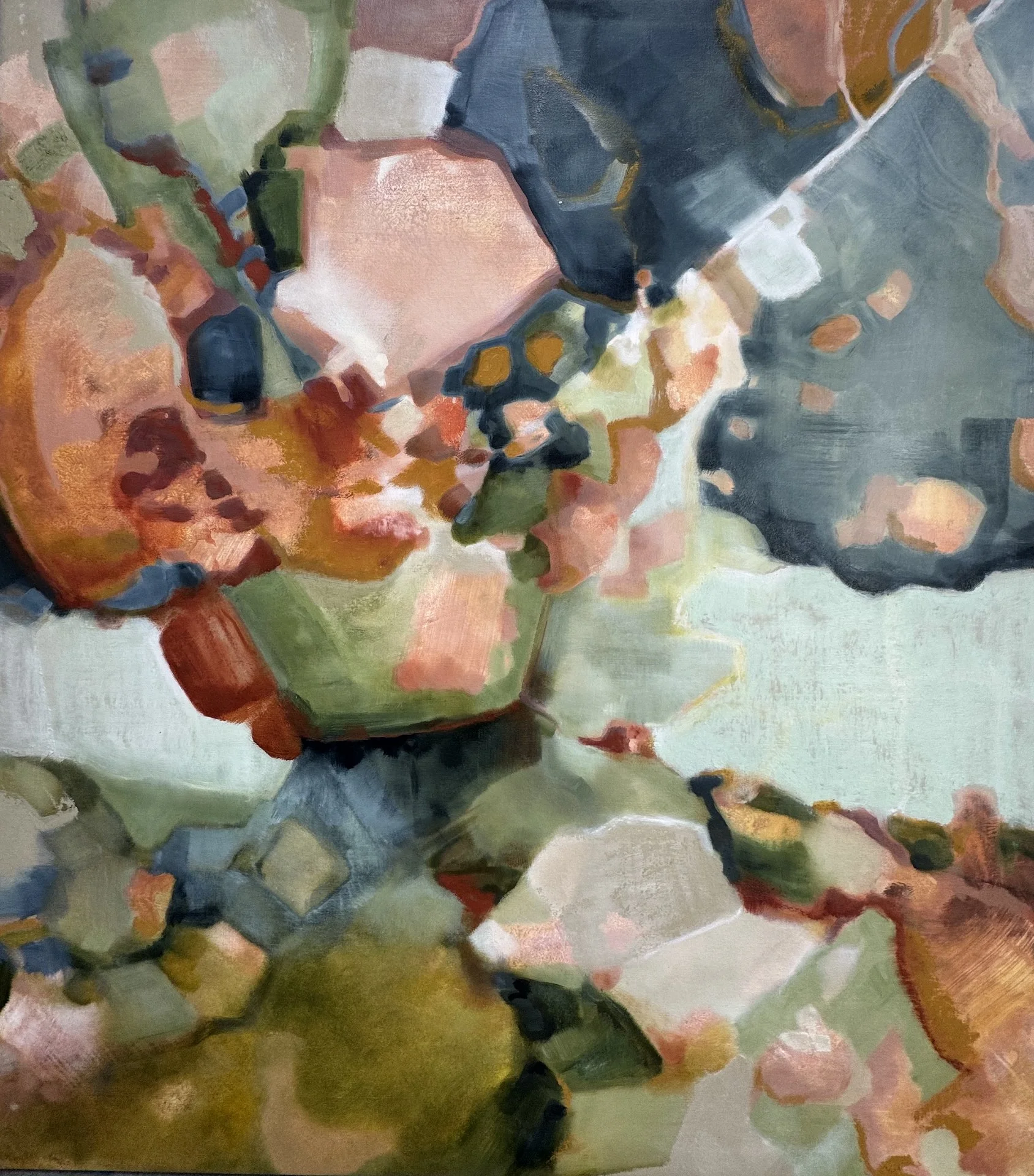 Close-up of an abstract flower painting with bold brushstrokes, featuring pink, green, blue, and orange colors, resembling a flower with soft petals and leaves.