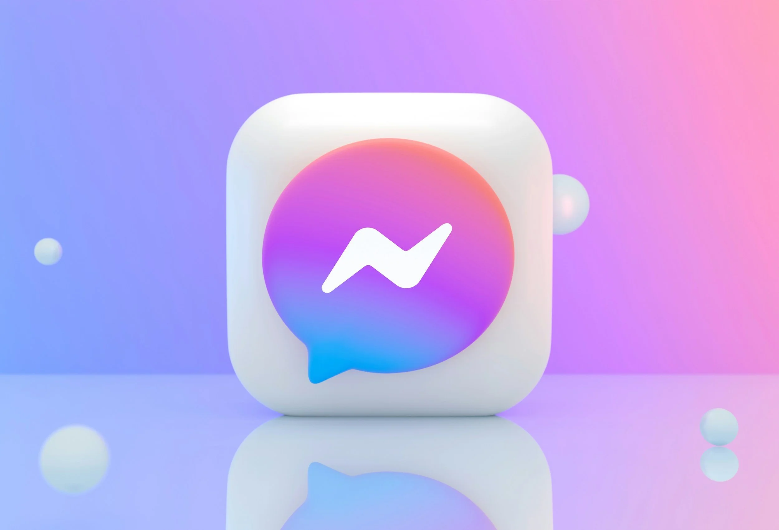 The Facebook Messenger app icon with a white speech bubble and a blue lightning bolt inside, displayed against a pastel-colored gradient background with floating spheres.