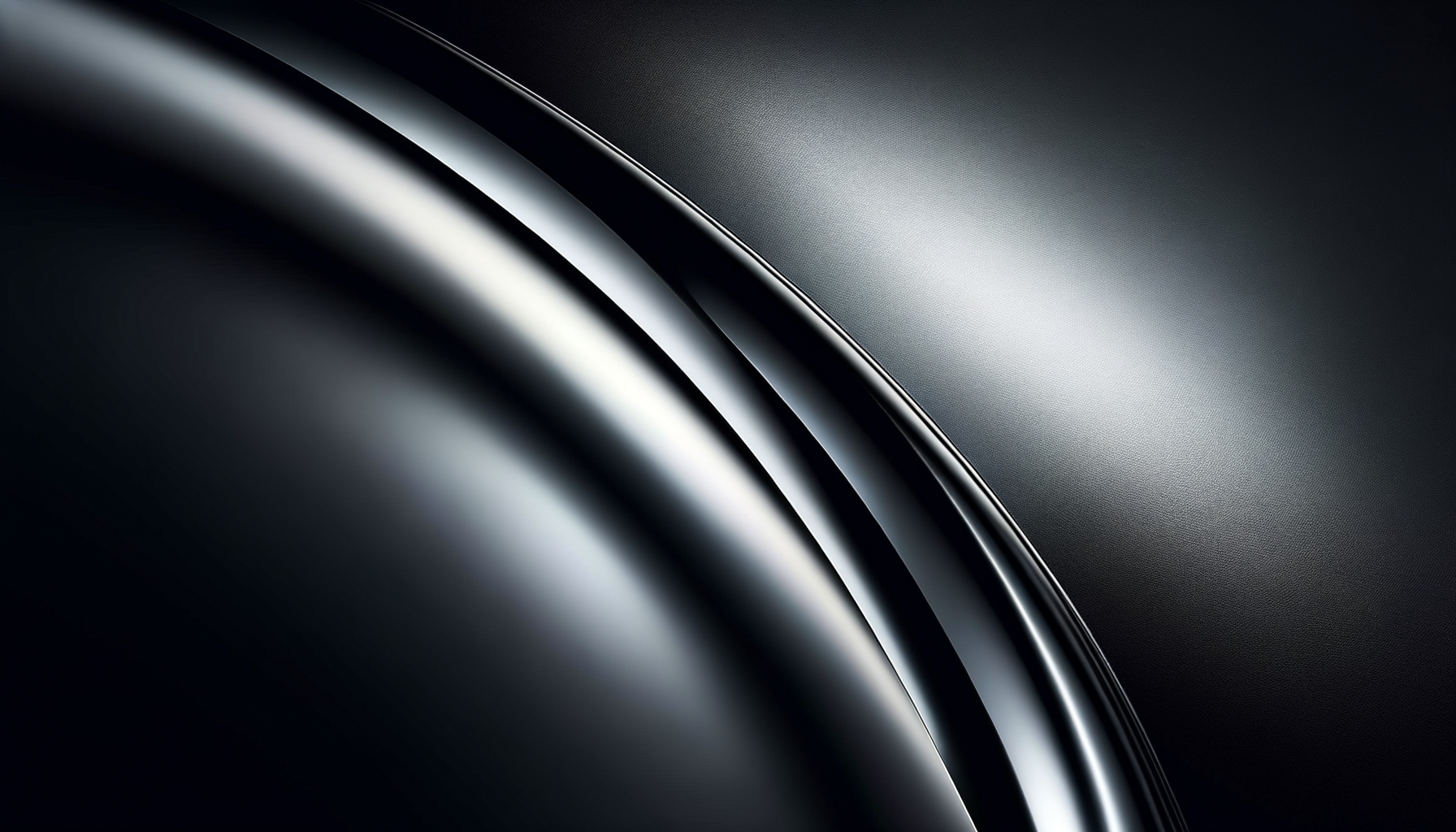 Close-up of a sleek, black, metallic surface with shiny curved lines and a textured finish, suggesting a modern, high-end object.
