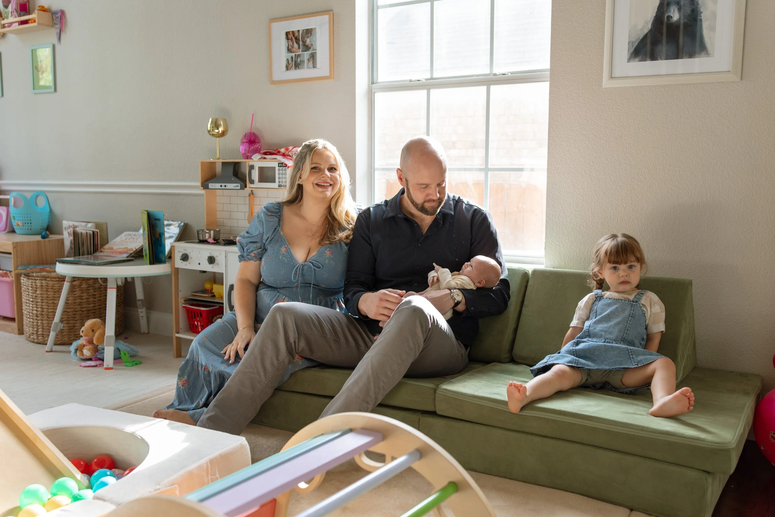 in home newborn photography session of family in colorful, sunny playroom, photo captured by Austin in home newborn photographer Hailey Copland. 