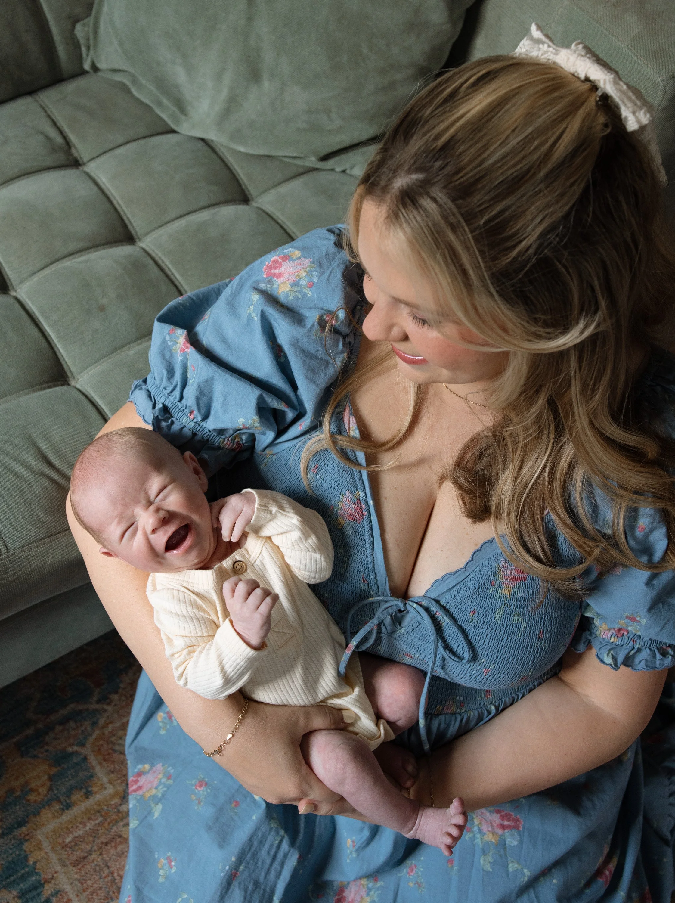 mom cuddles her newborn baby boy, photo captured by Austin in home newborn photographer Hailey Copland 