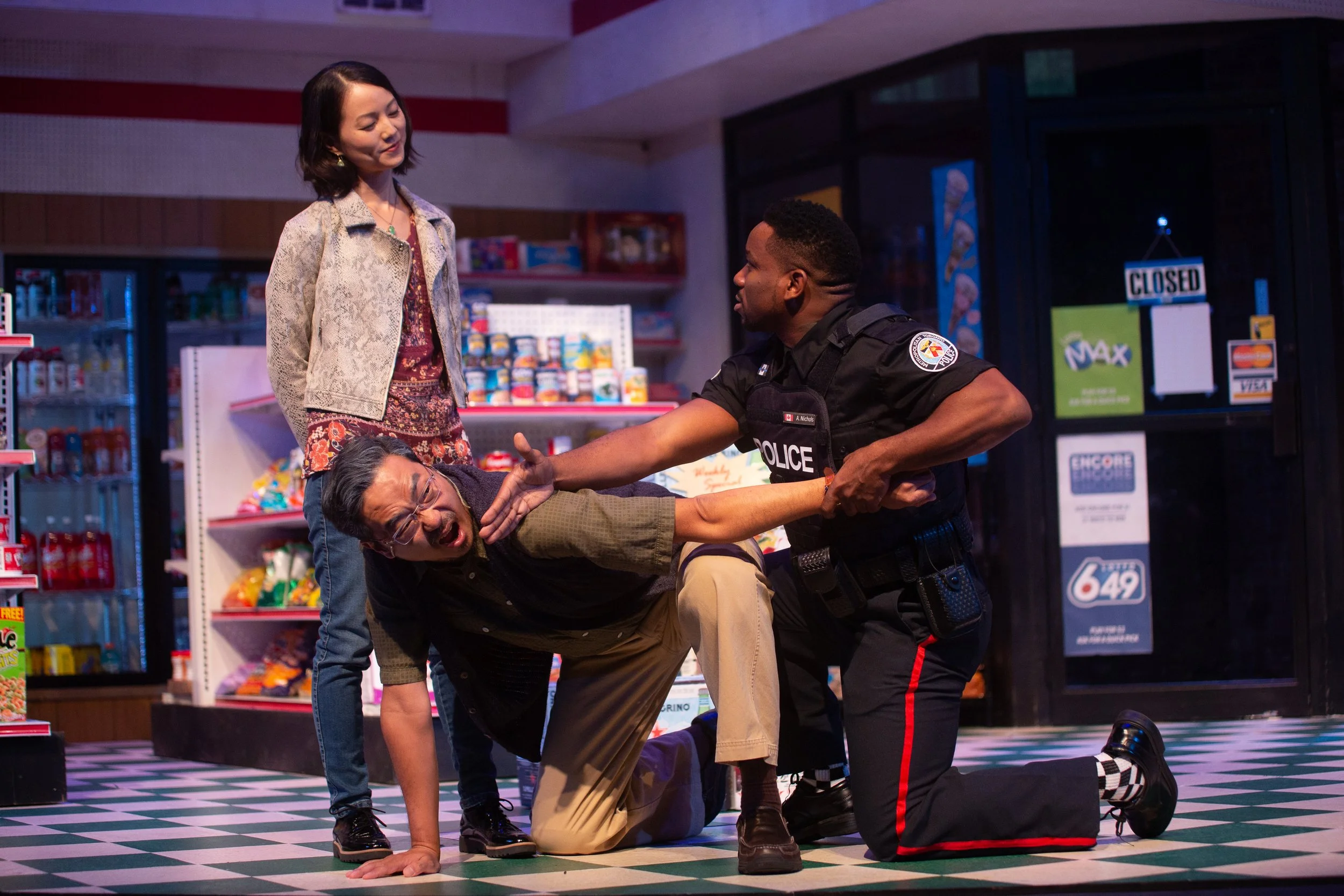 Susane Lee, Yong Kim, and Clinton Lowe share an awkwardly romantic moment in the Laguna Playhouse's award winning production of Kim's Convenience
