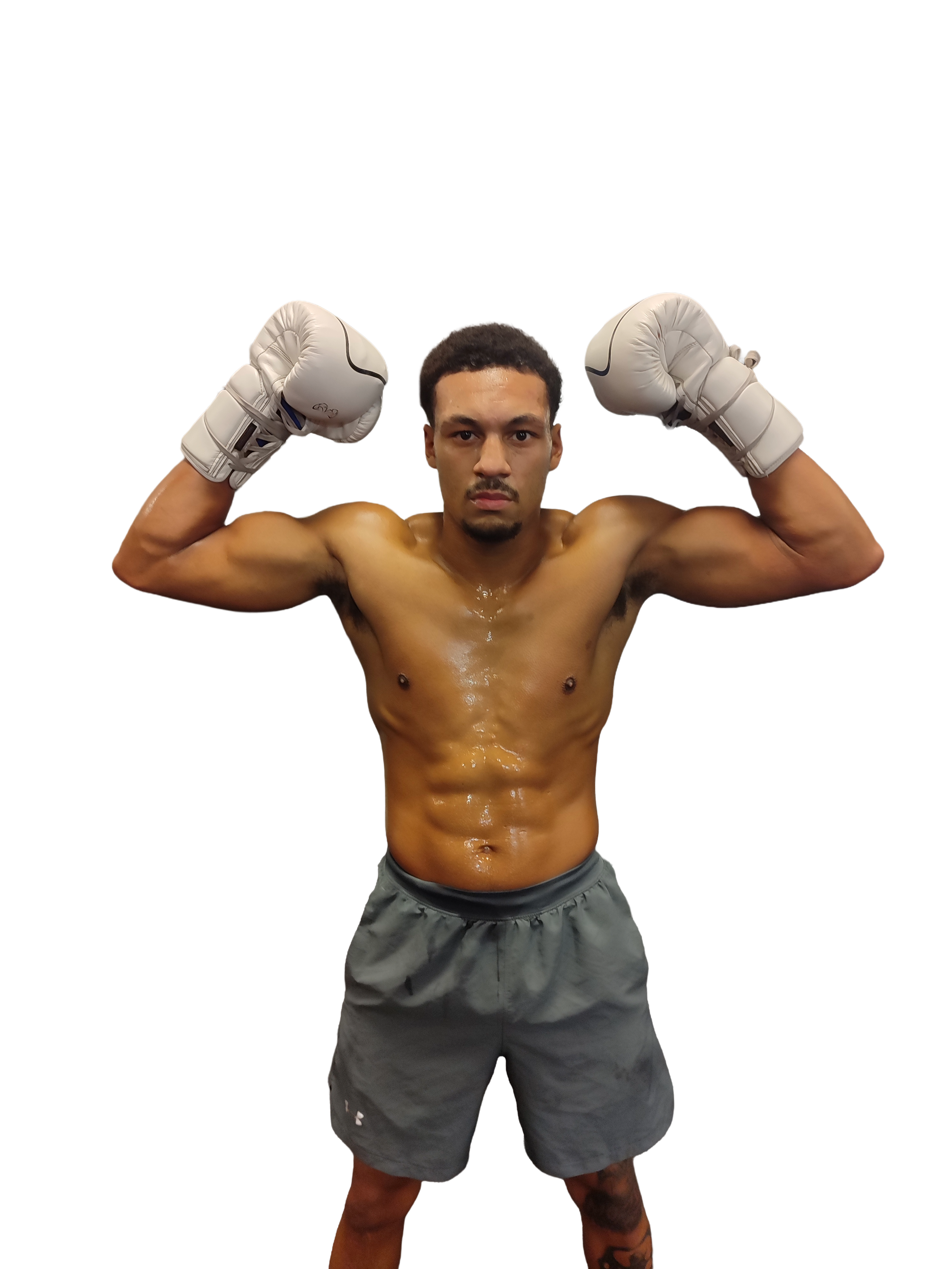 Woman sitting on a bench, writing in a notebook, with abstract art piece leaning against the wall beside her.