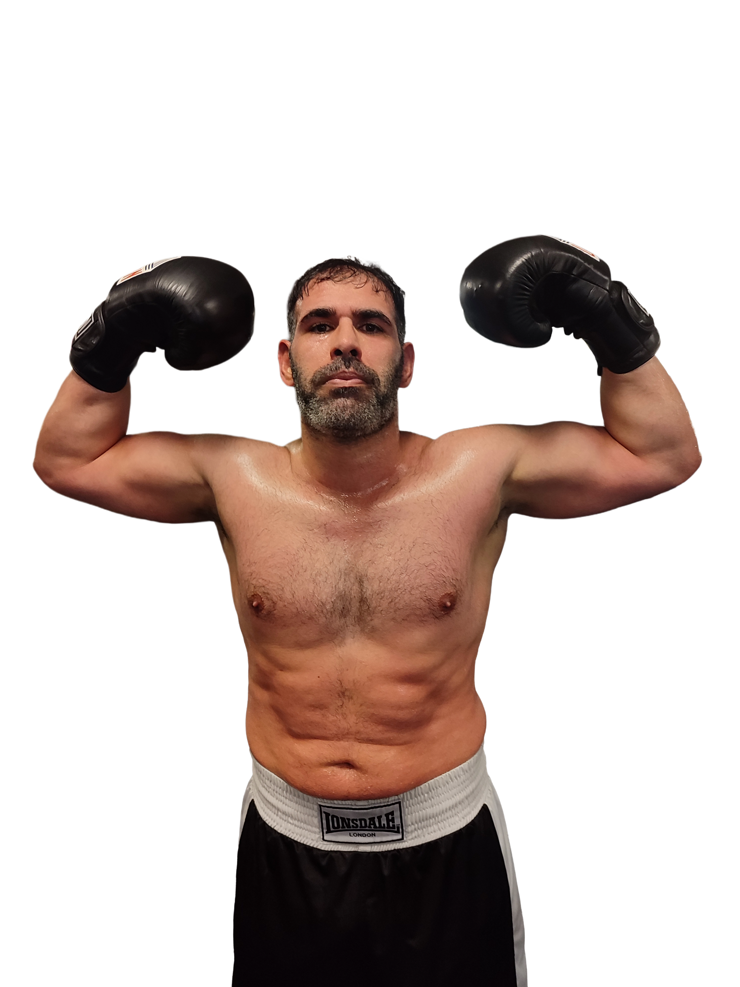 A man with gray hair sitting on a beige upholstered bench against a plain wall, looking to the side.