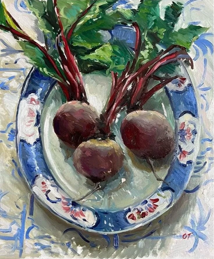 A painting of three beets on a decorative blue and white plate with green leaves in the background.