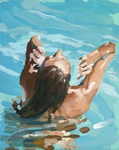 Person with long hair swimming in a pool.