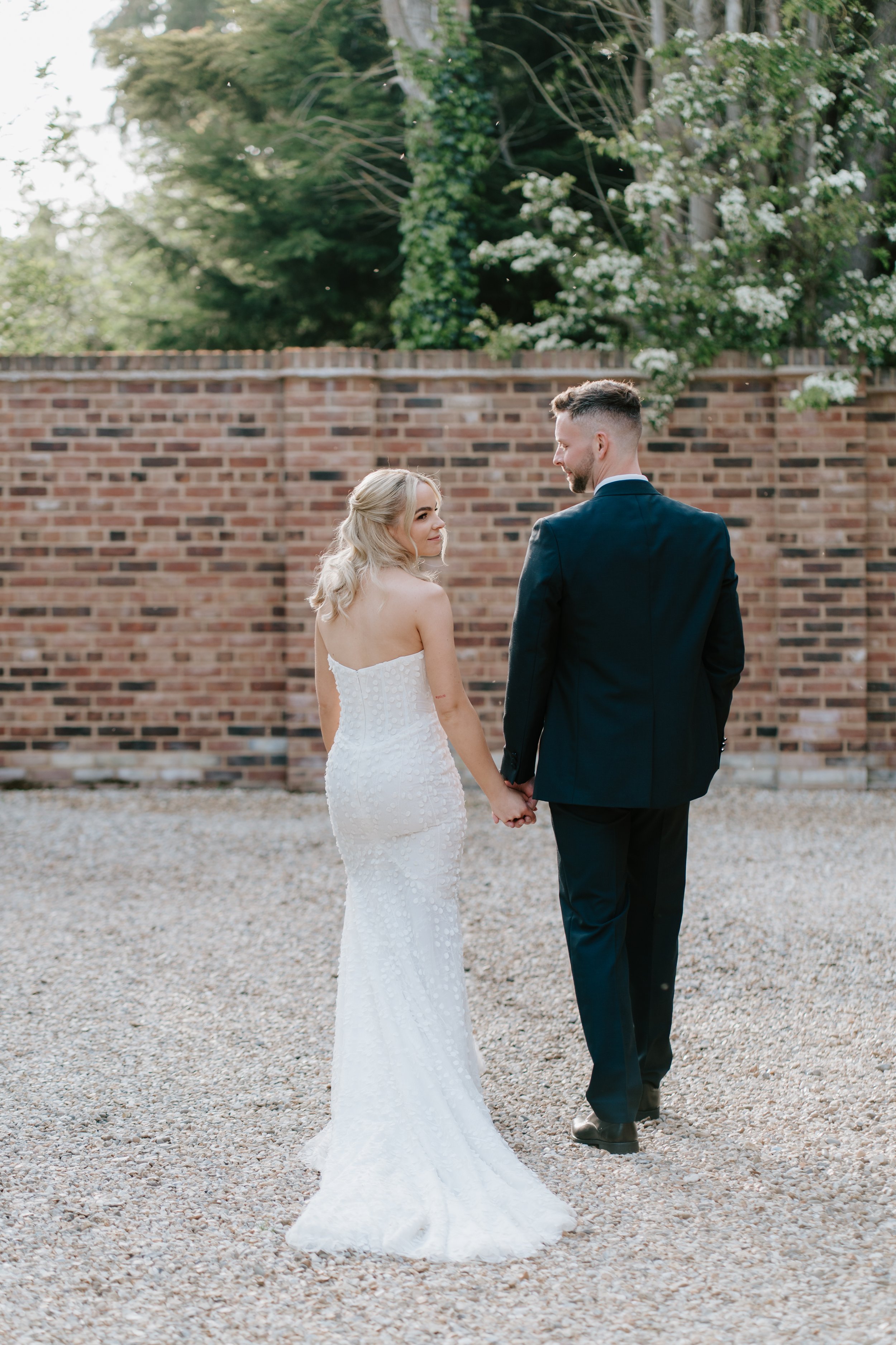 gemma-wythe-photography-norfolk-wedding-couple-walking-away.jpg