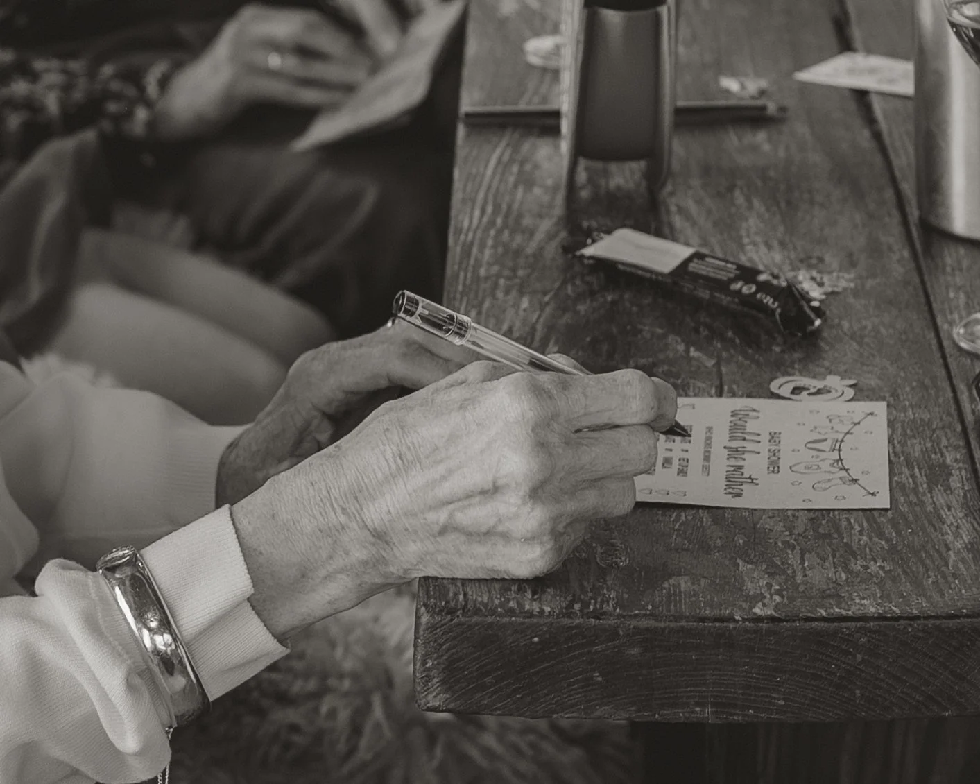Candid baby shower event photography at The Boathouse in Woodbridge, Suffolk, capturing guests taking part in a baby shower game, photographed by Gemma Wythe Photography.
