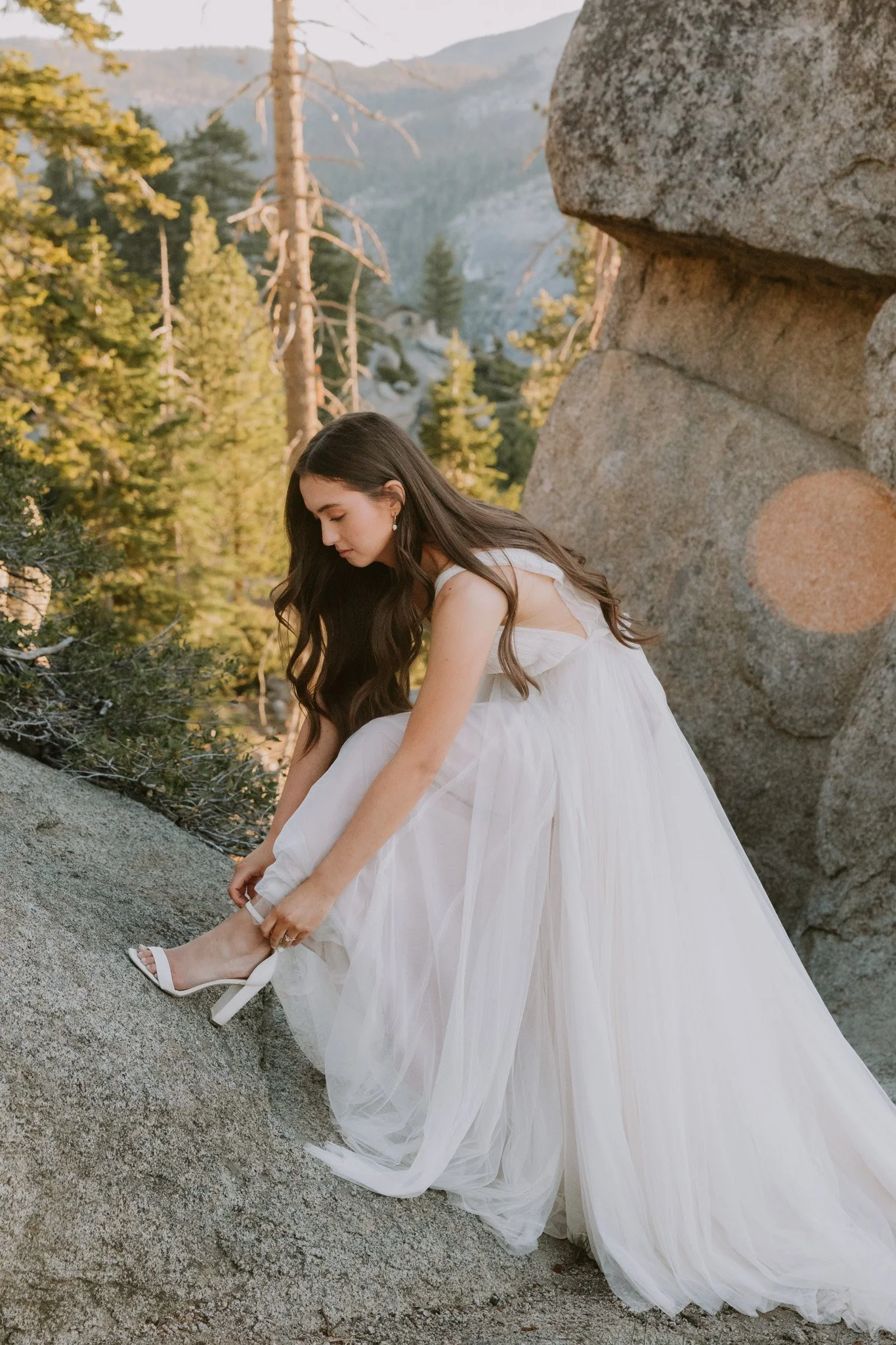 Bride gets ready and puts on her shoes as she prepares to elope in Yosemite National Park