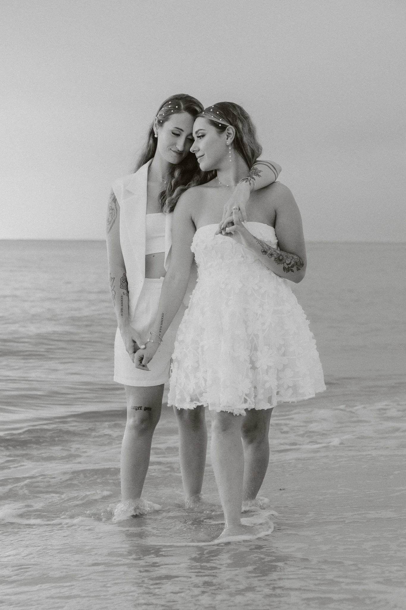 queer couple stands in the Gulf of Mexico for their first dance after their elopement
