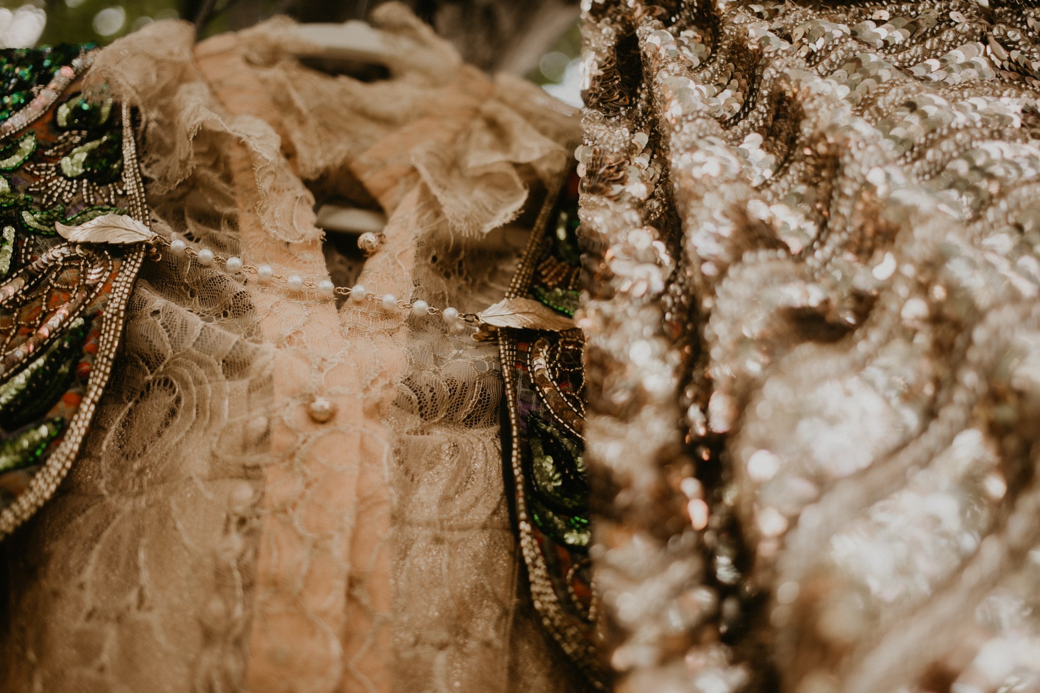 thrifted wedding outfits of gold hang in the trees together