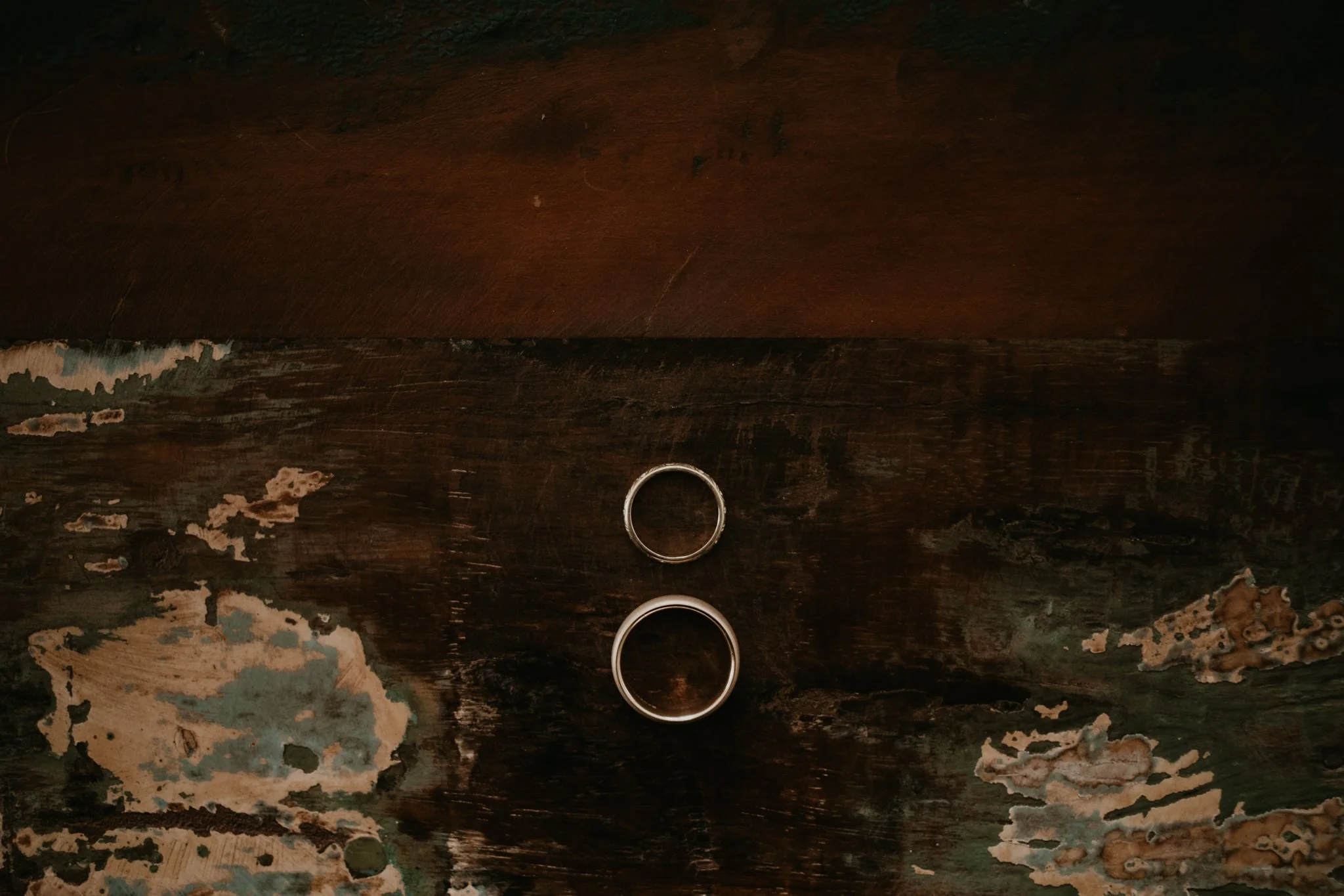 Two rings sit onto of a textured old wooden chest