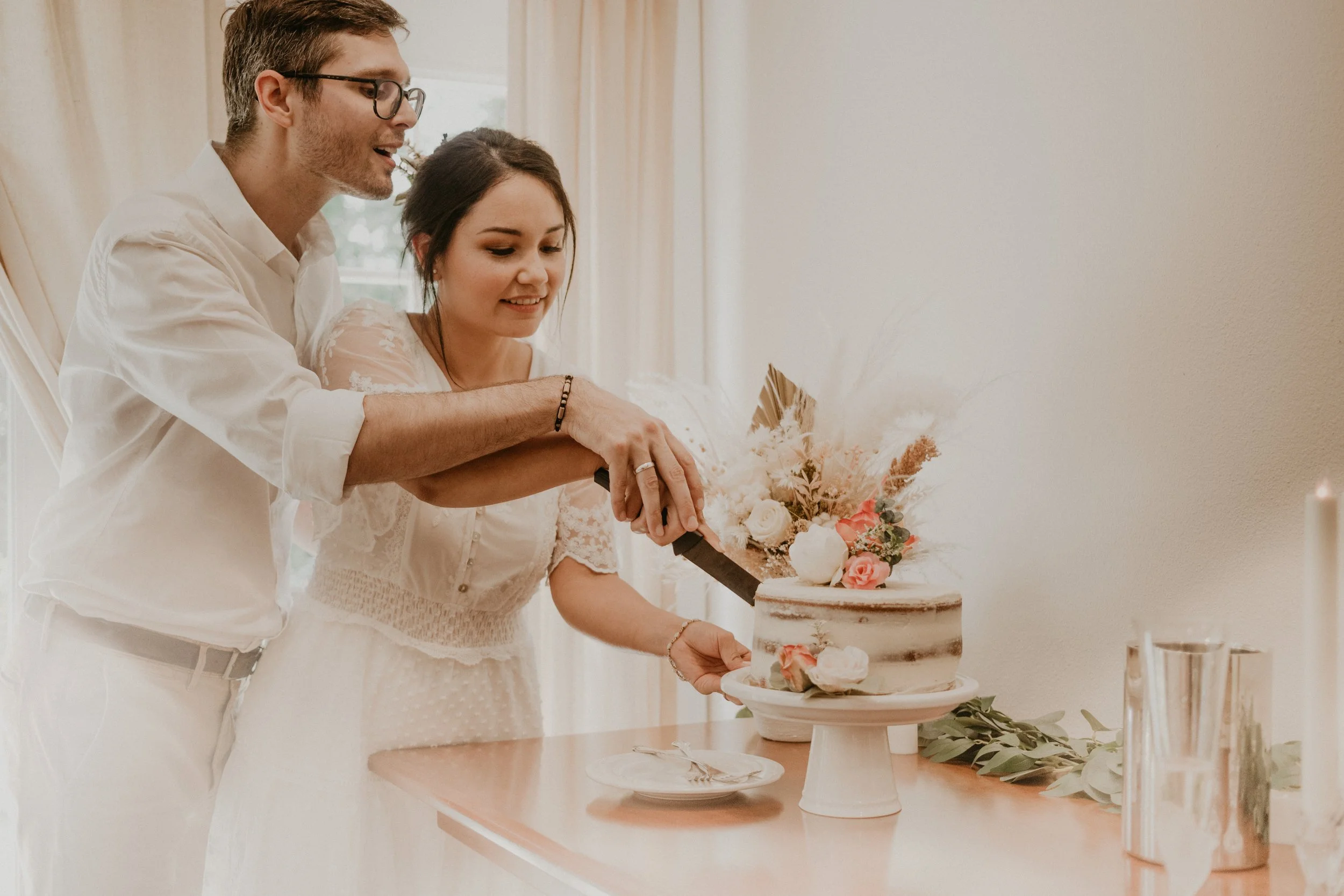 Bride and groom cut their homemade cake together