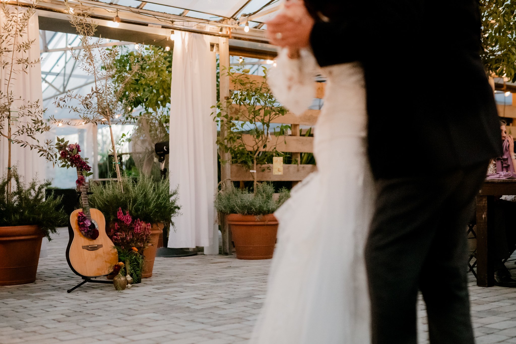 Lindsey and her step-father shared a tearful first dance as her fathers guitar sat in view, adorned with florals.