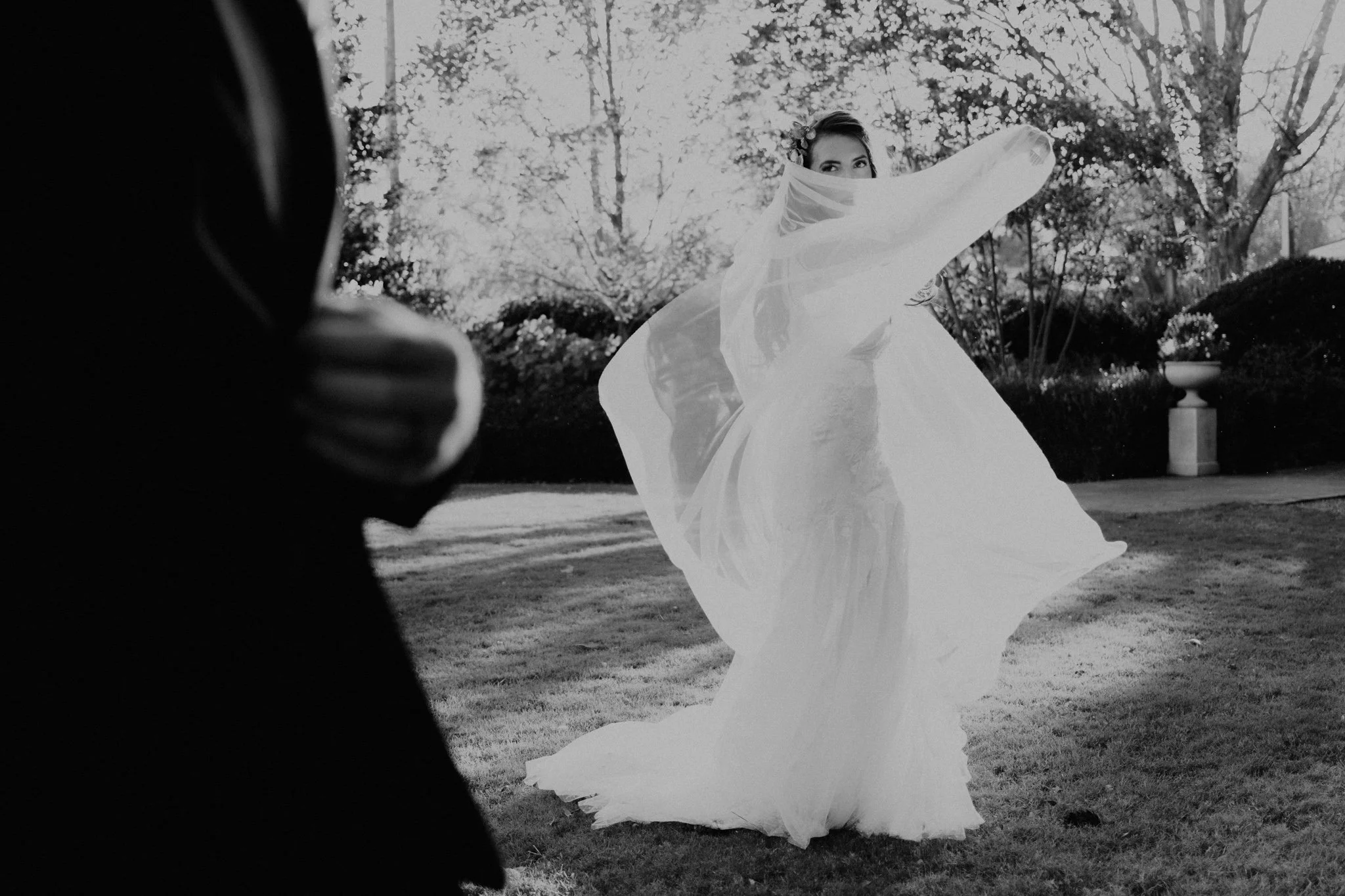 Lindsey plays with the fabric of her dress and veil, creating movement with the material, while Dune is watching in the foreground