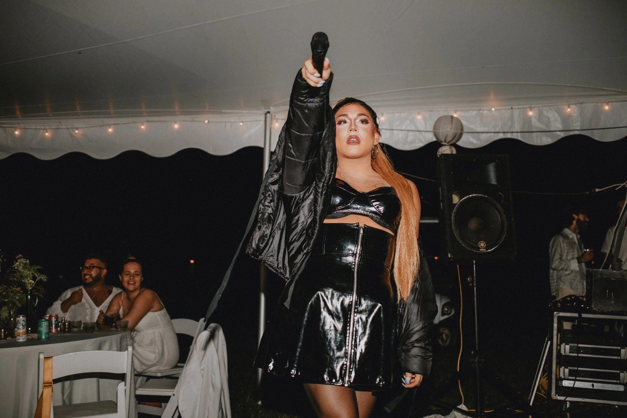 Ariana Grande impersonator points the mic towards the audience during a performance
