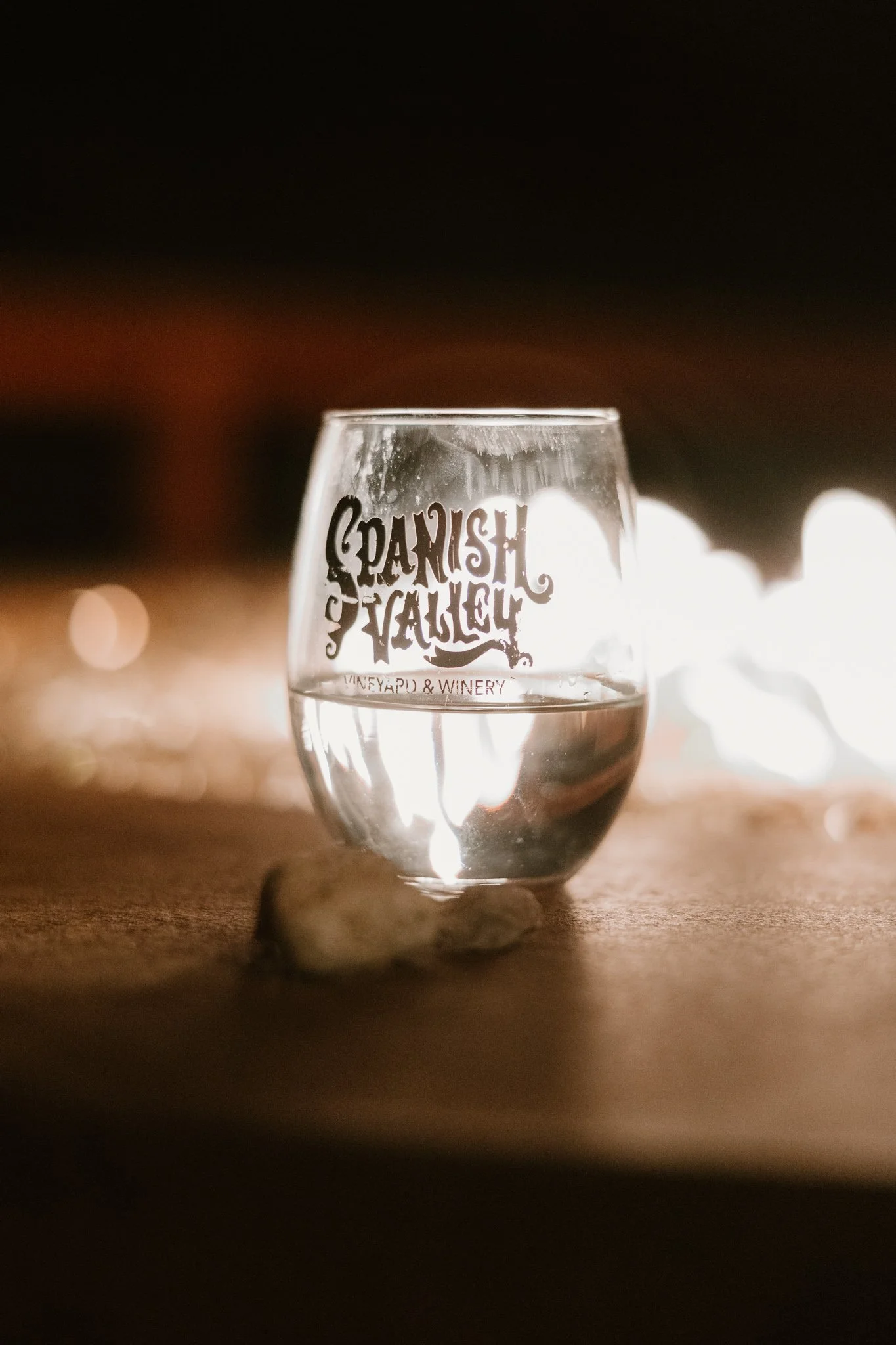 wine class with the Spanish valley logo, lit by a bonfire at a wedding ceremony