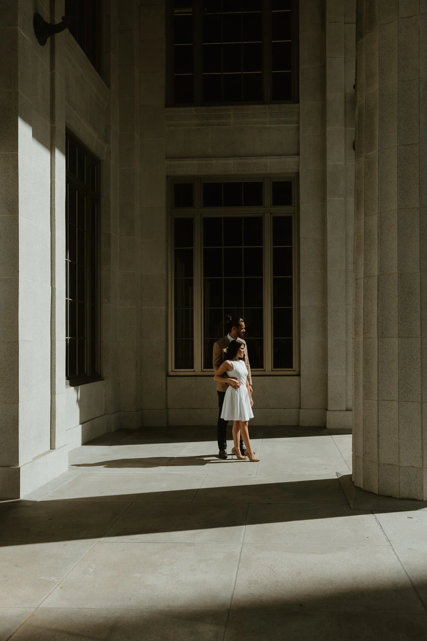Couple stands outside the Miami Courthouse for portraits, after their local elopement ceremony