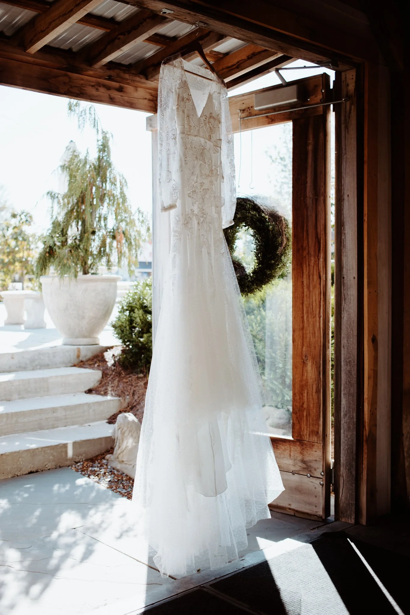 Lindseys lace adorned dress hangs in the doorway of the main building.