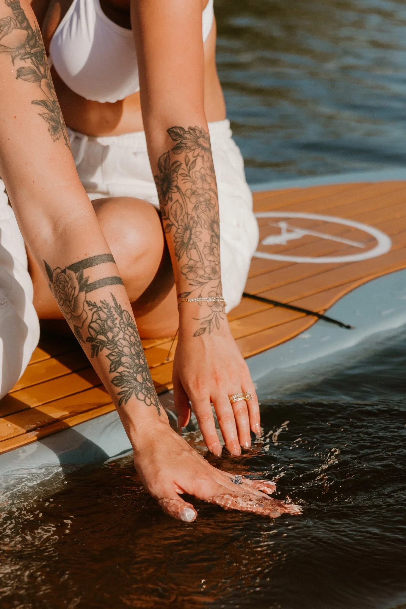 queer couple enjoys paddle boarding during their day after session in the Gulf of Mexico