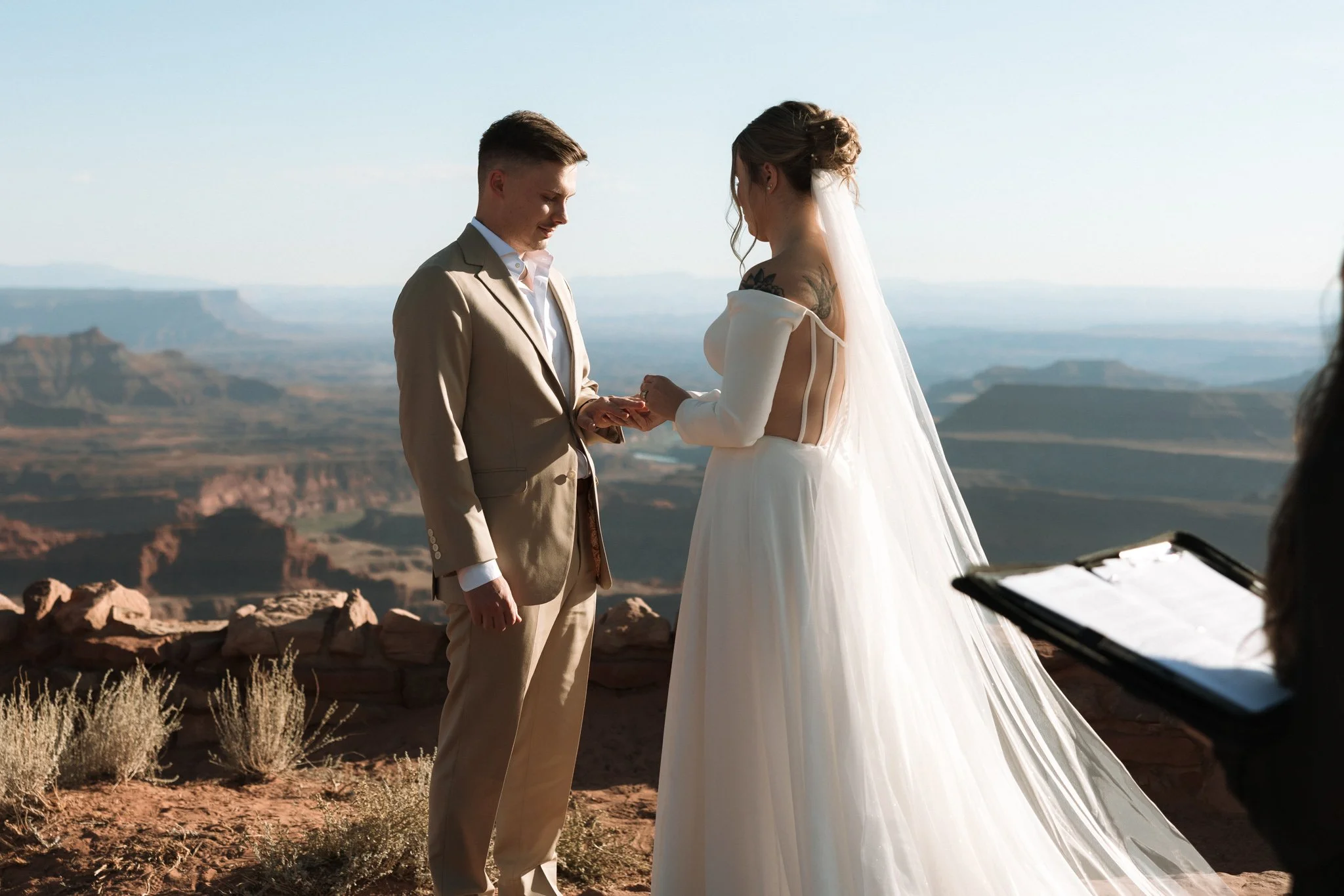 Wedding couple give rings during their ceremony at the West Bench ceremony site