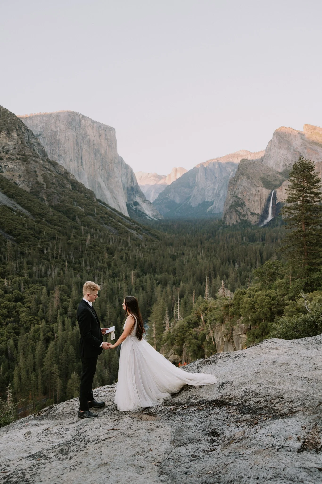 An elopement couple shares vows overlooking the valley floor in Yosemite
