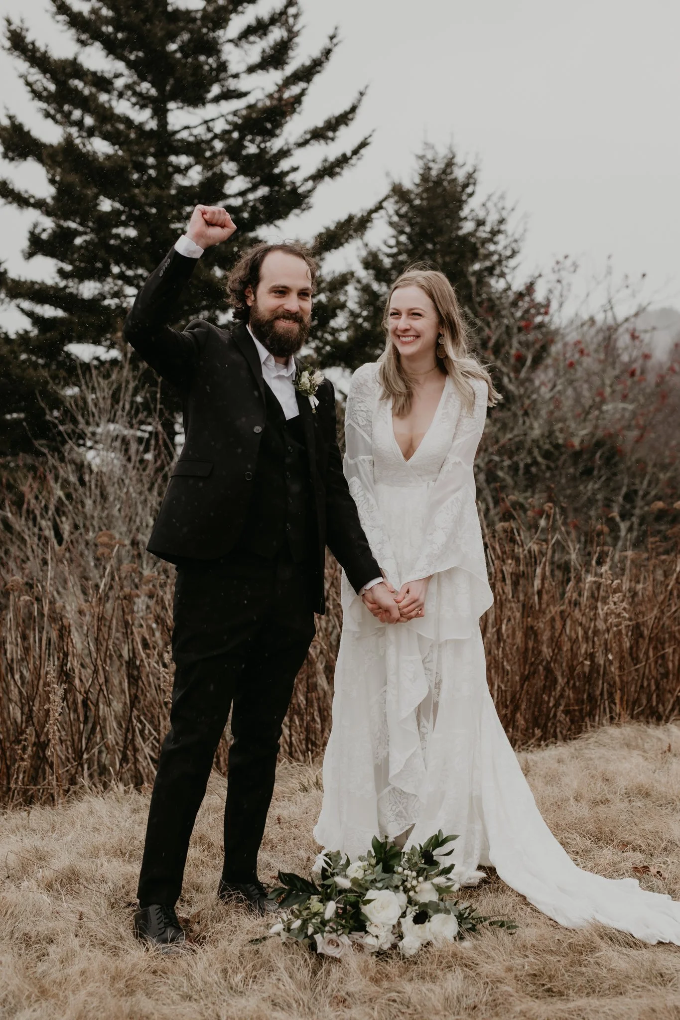A groom cheers in rejoice after finishing vows