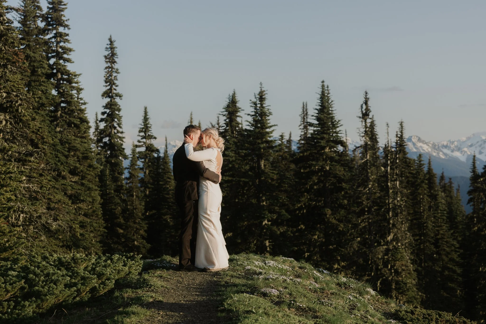 A wedding couple shares their first dance on a trail along the peak at Hurricane Ridge in Olympic National Park