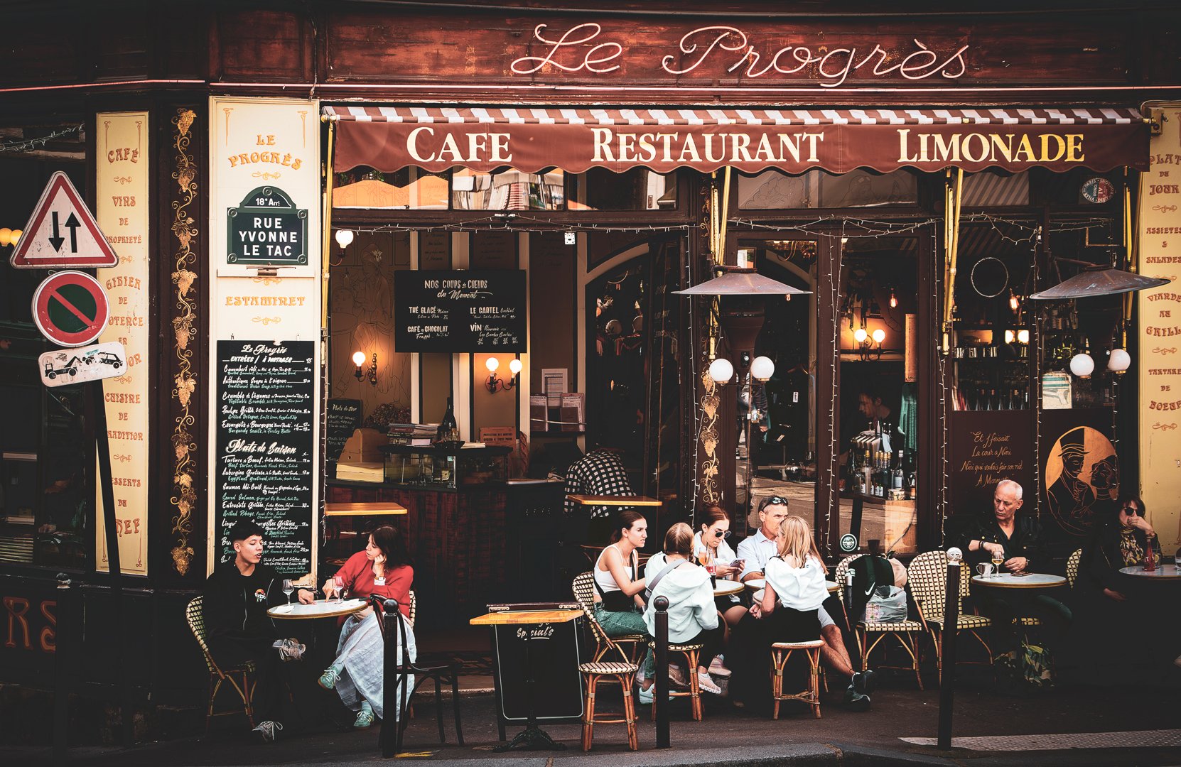 Beneath the soft glow of Le Progrès