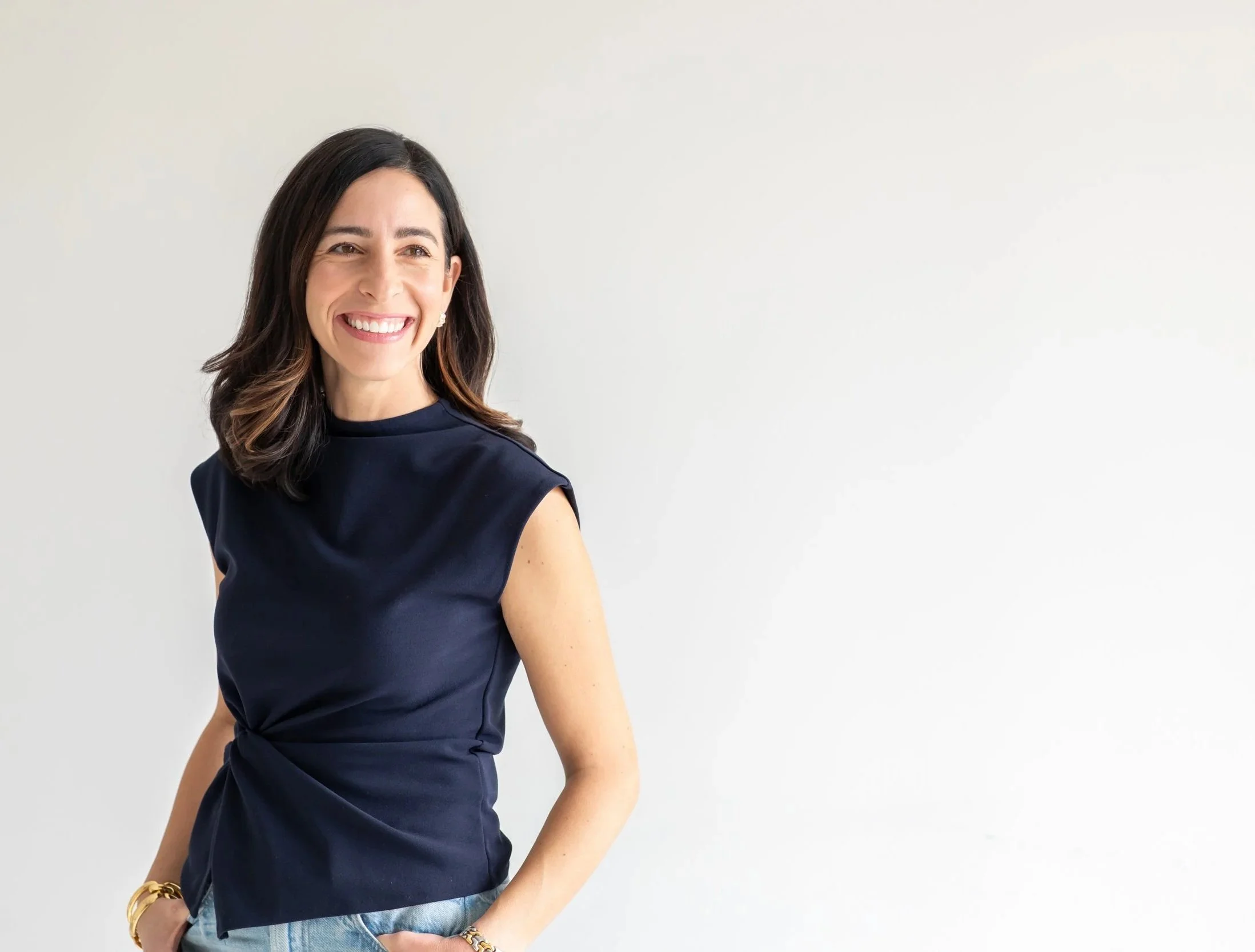 Kristin Wood, personal stylist and color analysis consultant, standing and smiling.