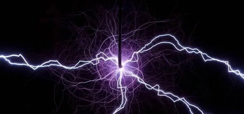 Close-up of lightning strike with bright purple and white electrical discharges against a dark sky.