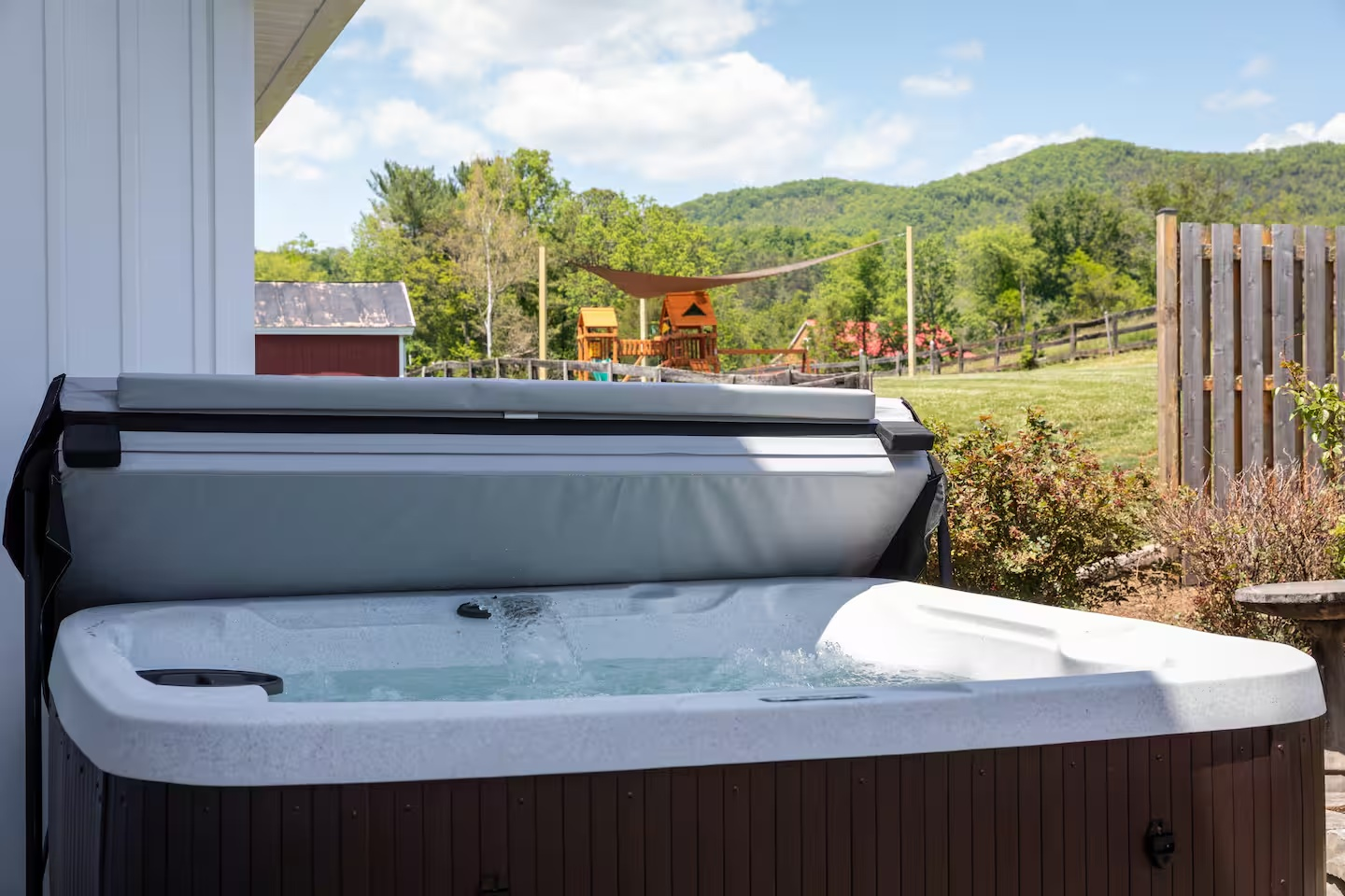 12-the-heritage-house-hot-tub-playground-view.png