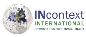 A 3D globe made of puzzle pieces next to a stack of three books with blue, green, and dark blue covers.