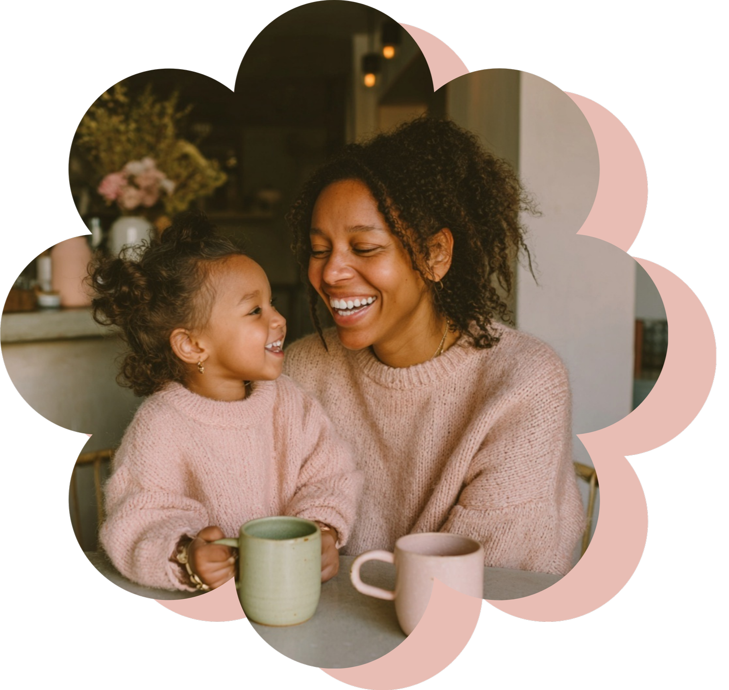 A joyful woman and young girl sharing a happy moment at a table, holding cups, smiling and looking at each other, in a cozy home setting.